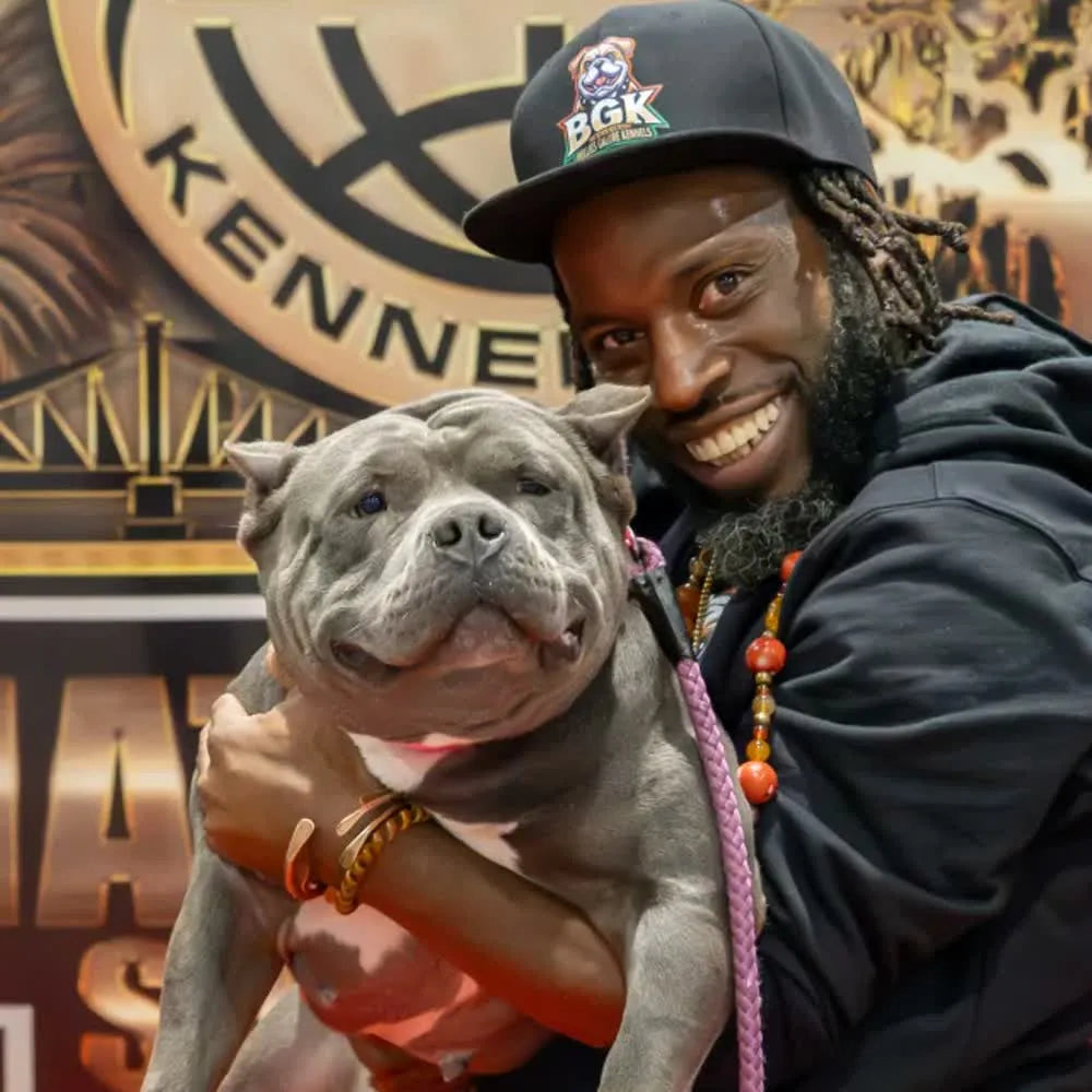 The founder of Bullies Galore Kennels holding one of the kennel's American Bullies at an ABKC show